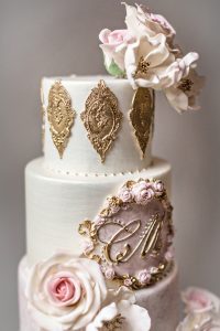 Amazing Vintage Custom Wedding Cake featuring gold lace and white and pink handcrafted sugar flowers. Luxury Wedding Cake by Master Sugar Artist Ana Parzych. CT, NYC, MA, RI.